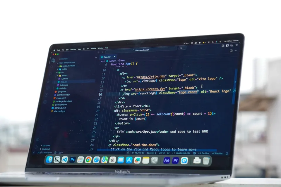 A developer comparing two website framework setups side by side on a laptop