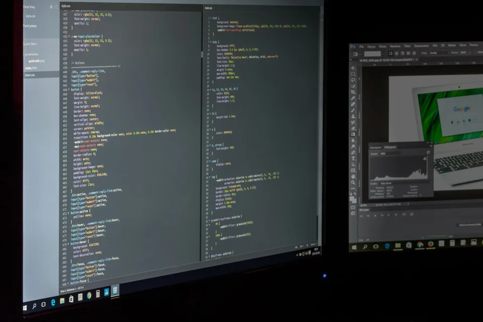 Developer configuring domain settings and DNS records on a laptop