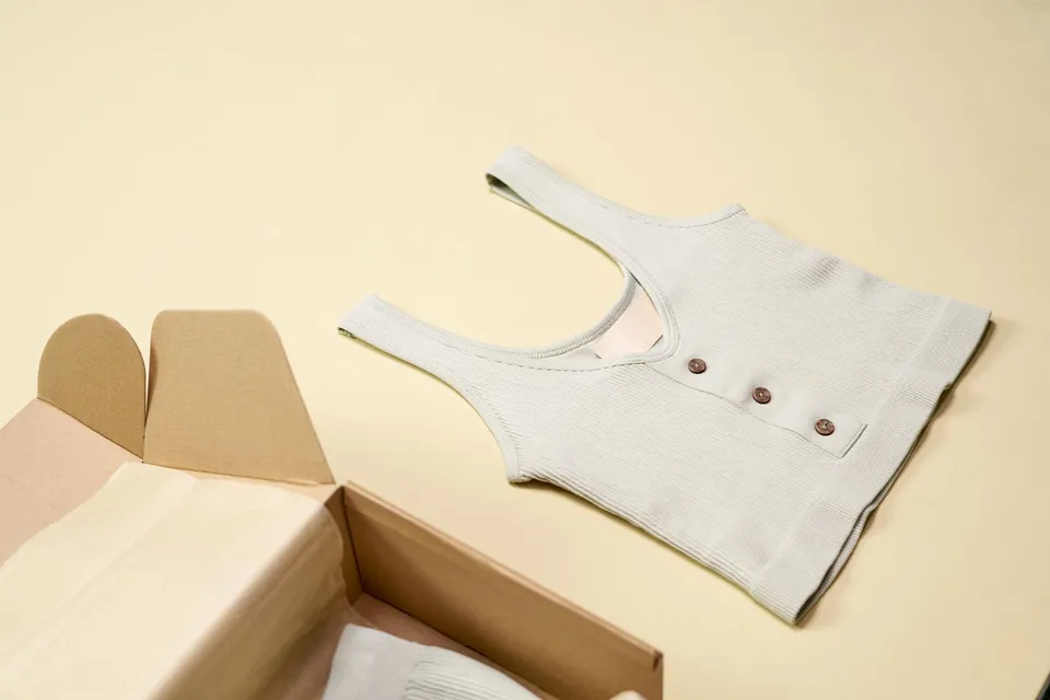 Product packaging and clothing laid out for online store catalog photography