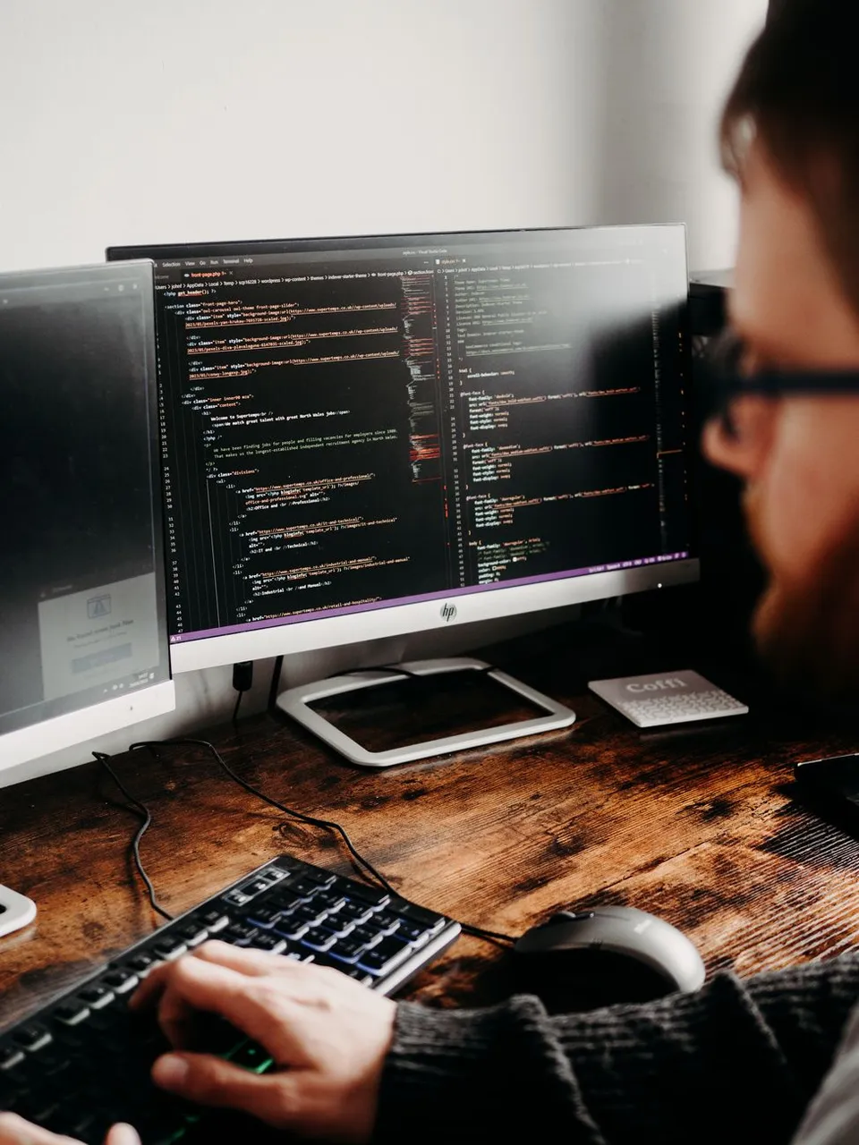 A software developer building a custom application dashboard at a desk