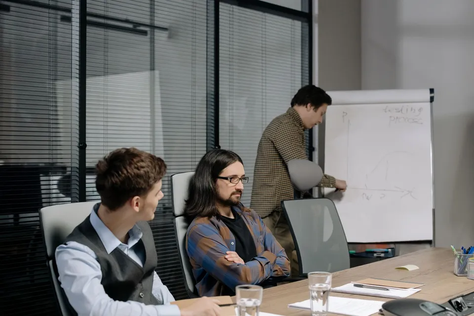 A team in a meeting discussing options for choosing a website platform